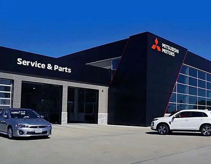 Cars pulled up outside a Mitsubishi Motors Services and Parts Center to get a Diamond Premium Care treatment